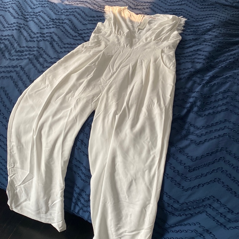 Francesca’s white jumpsuit with lace detail